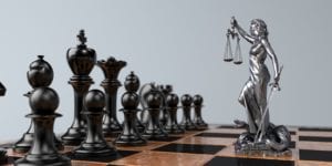 Chess board with Lady Justice figurine 
