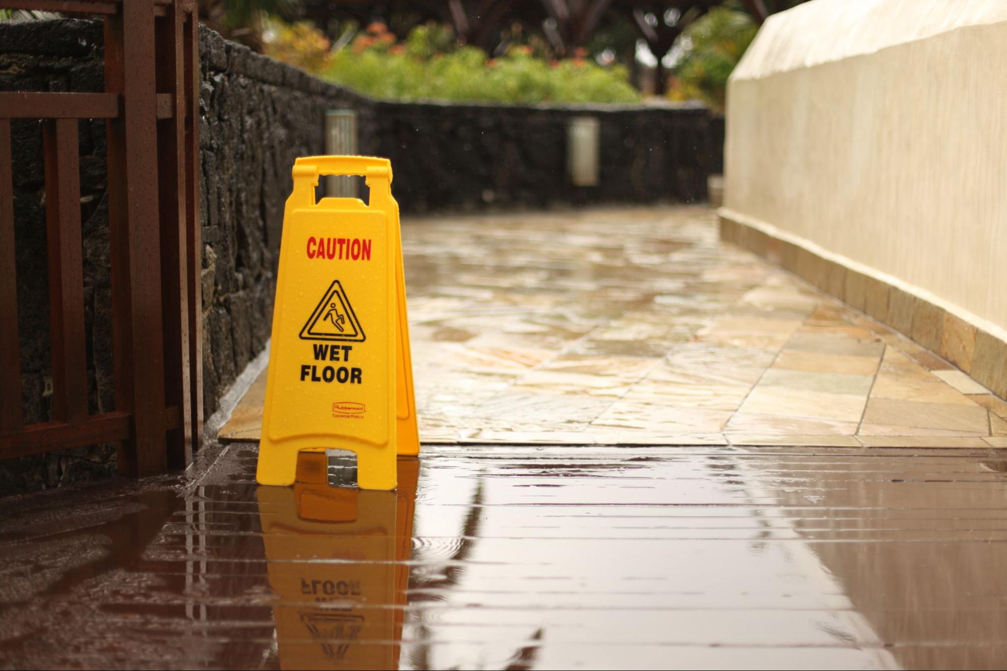 Yellow caution sign on a wet floor