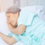 Elderly woman lying in bed