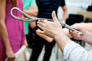 man holding an obstetric forceps
